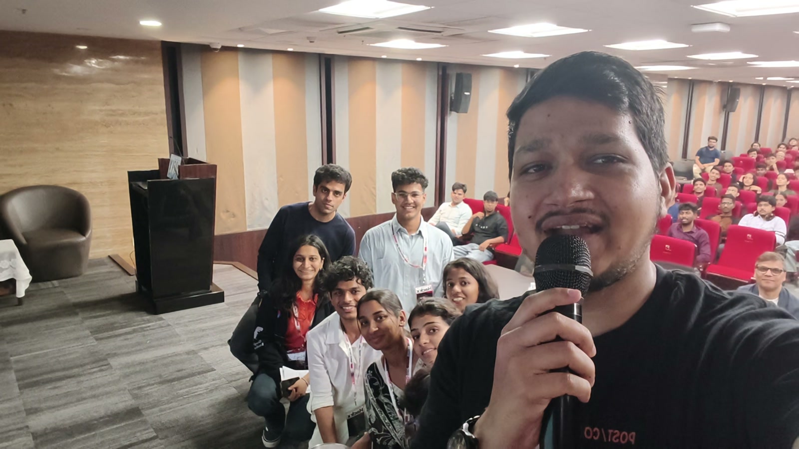 Ali Mustufa Shaikh holding a microphone with HackX4.0 participants at Narsee Monjee Institute of Management Studies (NMIMS), Navi Mumbai Campus in Kharghar.